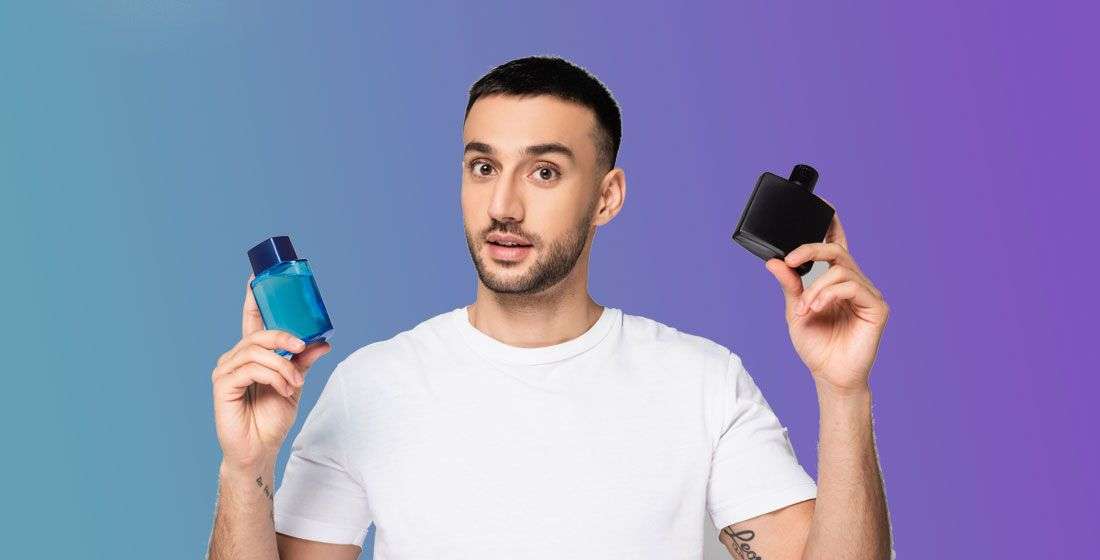 man holding perfume bottles