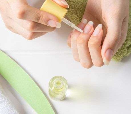 applying cuticle oil on nails